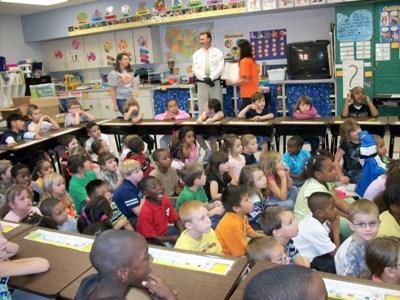 An elementary school class having show and tell.