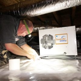 A pest technician treating fungus in a crawl space.