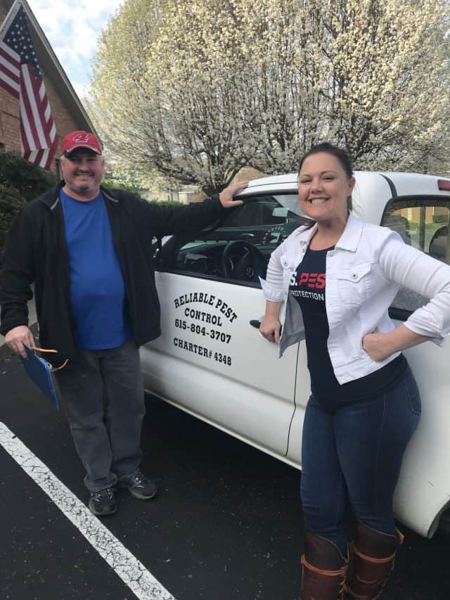 US Pest President Erica Brister stands next to a white truck for a business recently acquired.