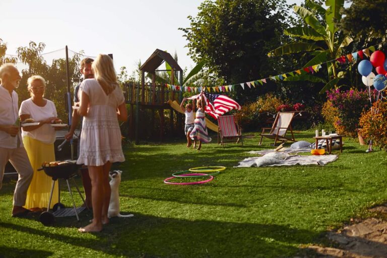 A family grilling for a Fourth of July party in their backyard.