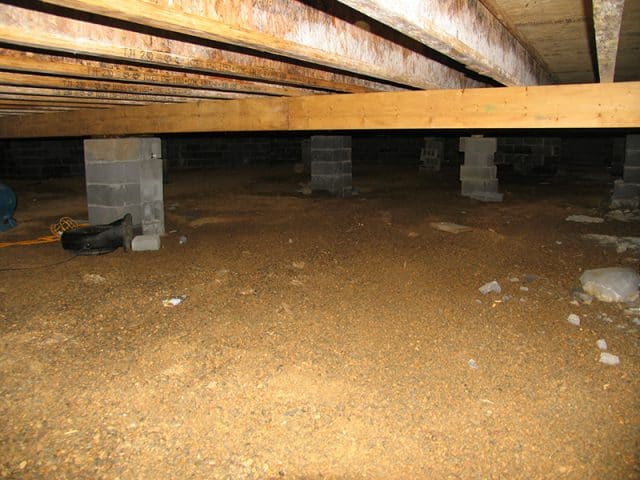 The crawl space underneath a trailer home.