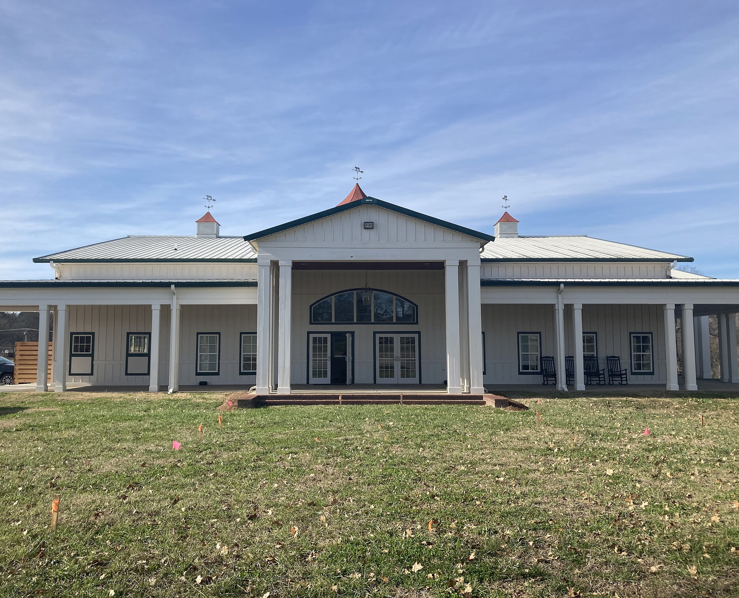 Historic white farm-style building with columned entrance in Thompson's Station, Tennessee