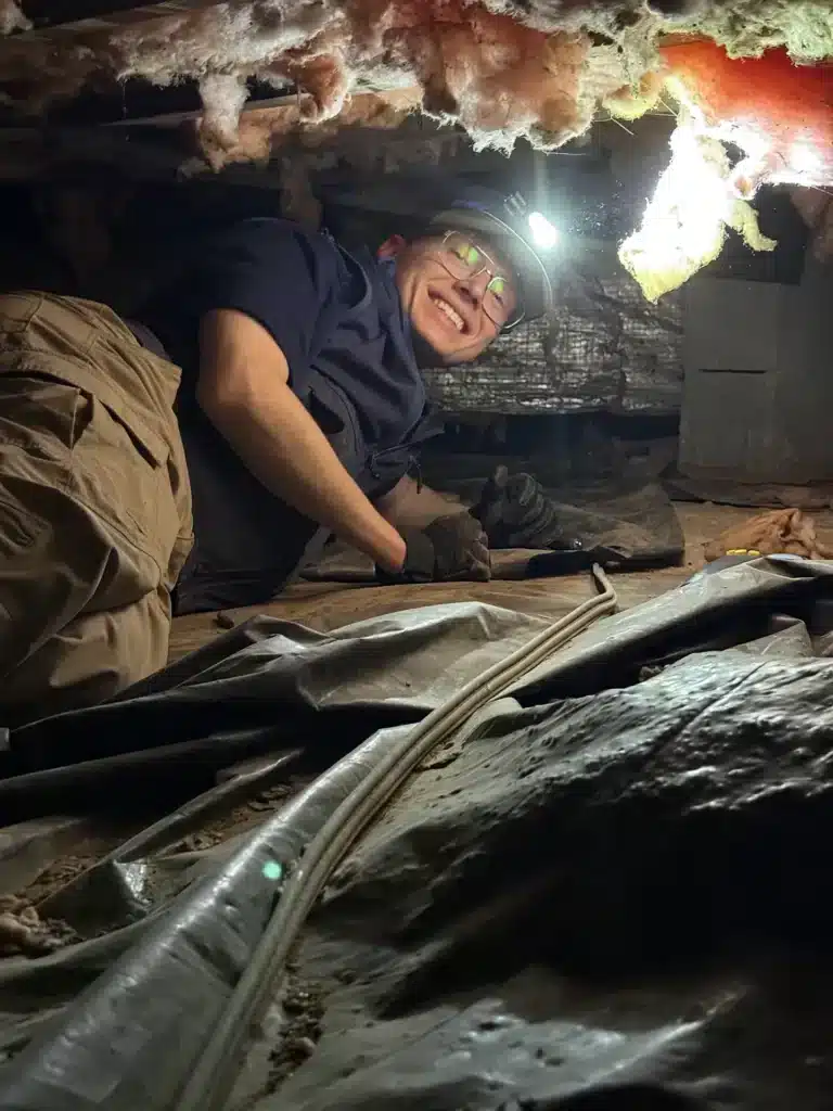 U.S. Pest Protection technician inspecting a crawlspace beneath a Middle Tennessee home for pest activity