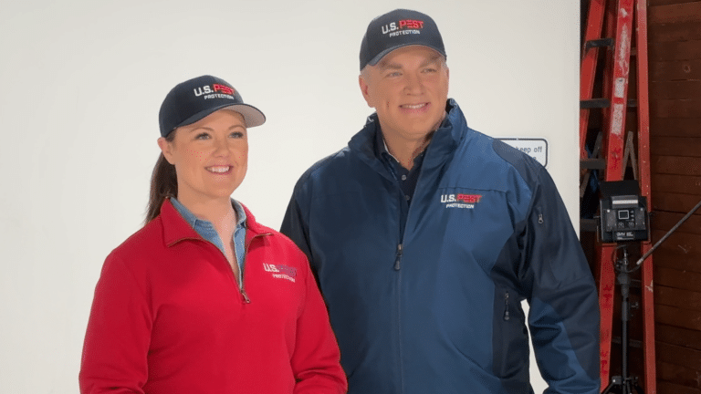 J.K. Brister and Erica Brister of U.S. Pest Protection on set in U.S. Pest jackets and caps